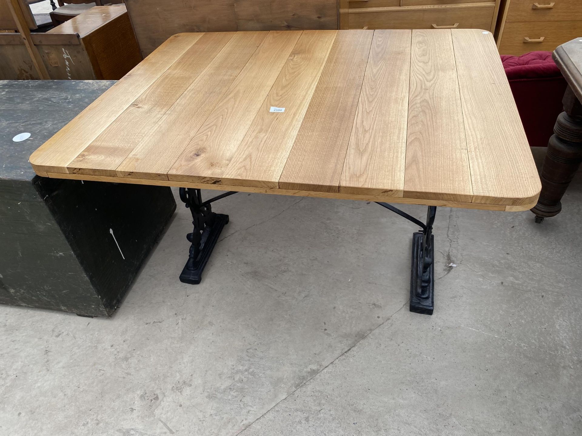 AN OAK PUB TABLE ON CAST BASE, 45 X 36"