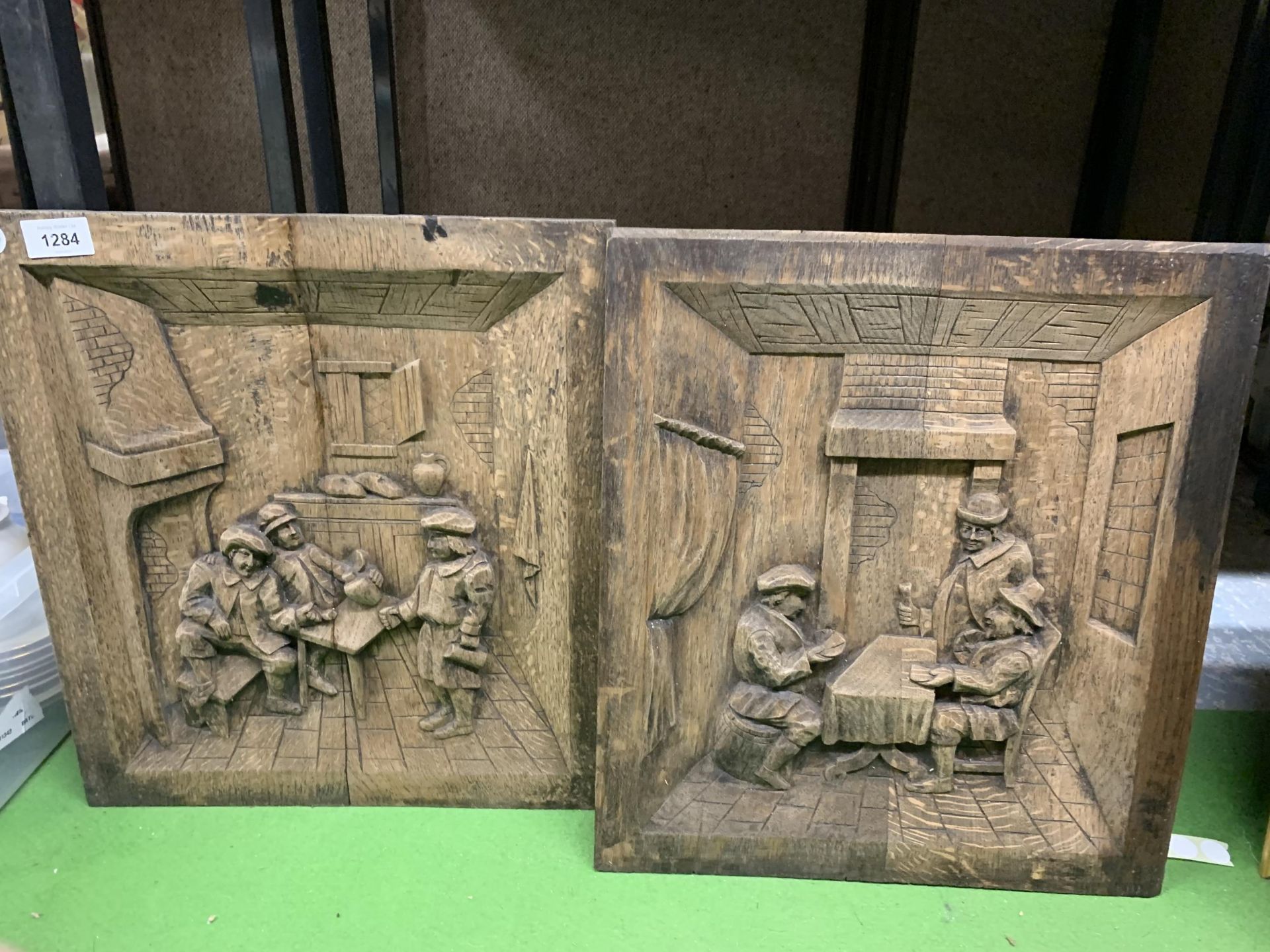 TWO OAK CARVED PANELS OF VINTAGE TAVERN SCENES 38CM X 42CM