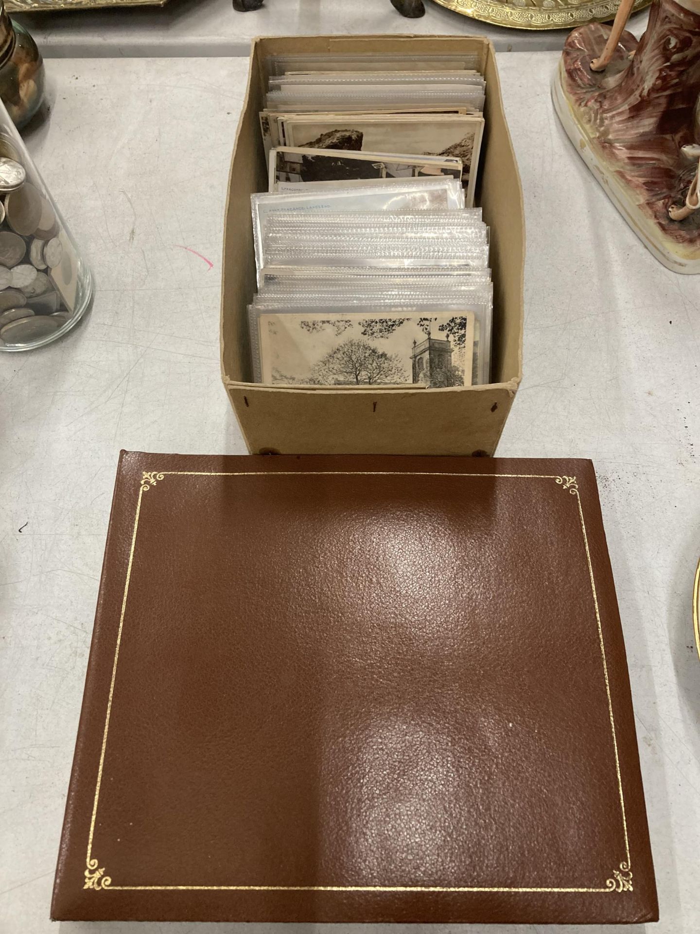 A POSTCARD ALBUM WITH POSTCARDS PLUS A LARGE QUANTITY OF LOOSE VINTAGE POSTCARDS IN PLASTIC SLEEVES