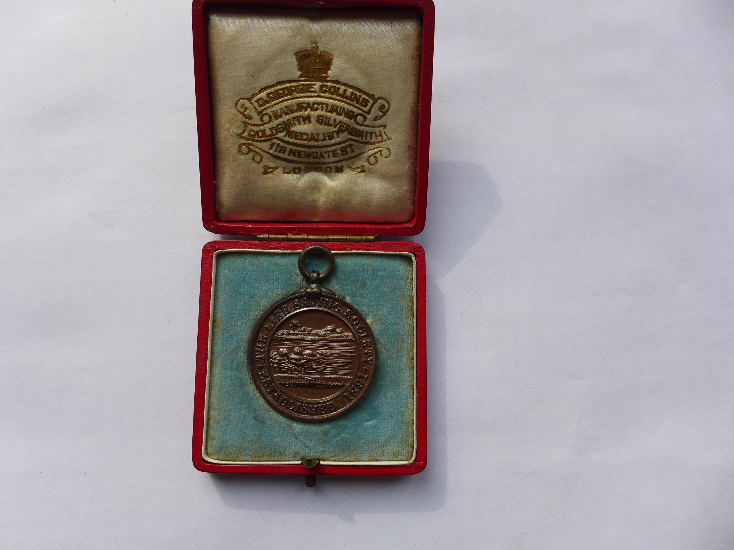 A CASED EDWARD VII BRONZE LIFE SAVING MEDAL, 32MM, AWARDED TO H ARSCOTT OCTOBER 1903