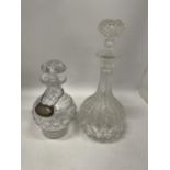 TWO CUT GLASS DECANTERS TOGETHER WITH A VINTAGE SILVER PLATED WHISKY DECANTER LABEL