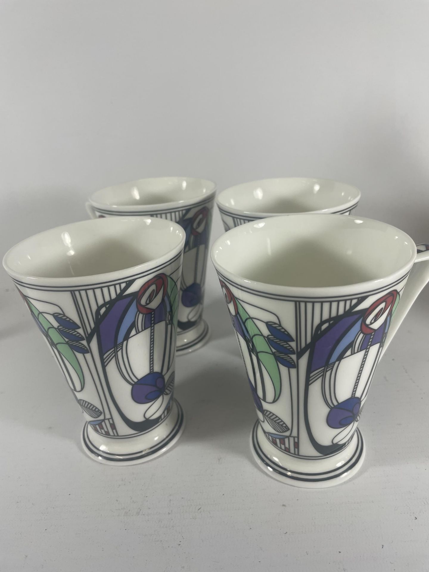 A SET OF FOUR WREN RENNIE MACKINTOSH PATTERN MUGS