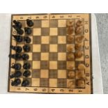 A FOLDING CHESS/BACKGAMMON SET WITH CHESS PIECES