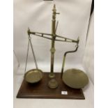 A VINTAGE SET OF WEIGHING SCALES WITH PANS AND GRADUATED SET OF FIVE WEIGHTS