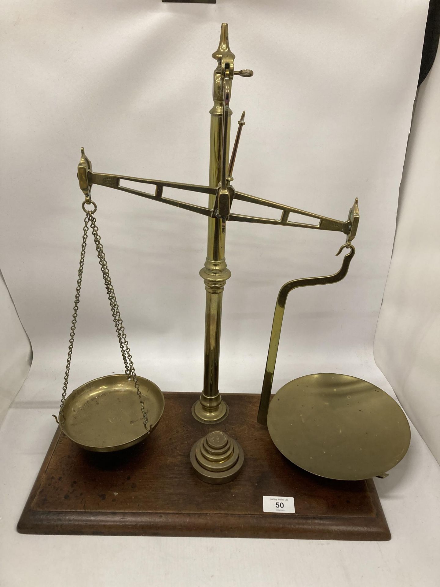 A VINTAGE SET OF WEIGHING SCALES WITH PANS AND GRADUATED SET OF FIVE WEIGHTS