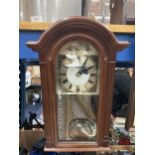 A VINTAGE STYLE WALL CLOCK WITH KEY AND PENDULUM - WORKING AT TIME OF CATALOGUING
