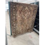 A VINTAGE HAND KNOTTED RED PATTERNED FRINGED RUG