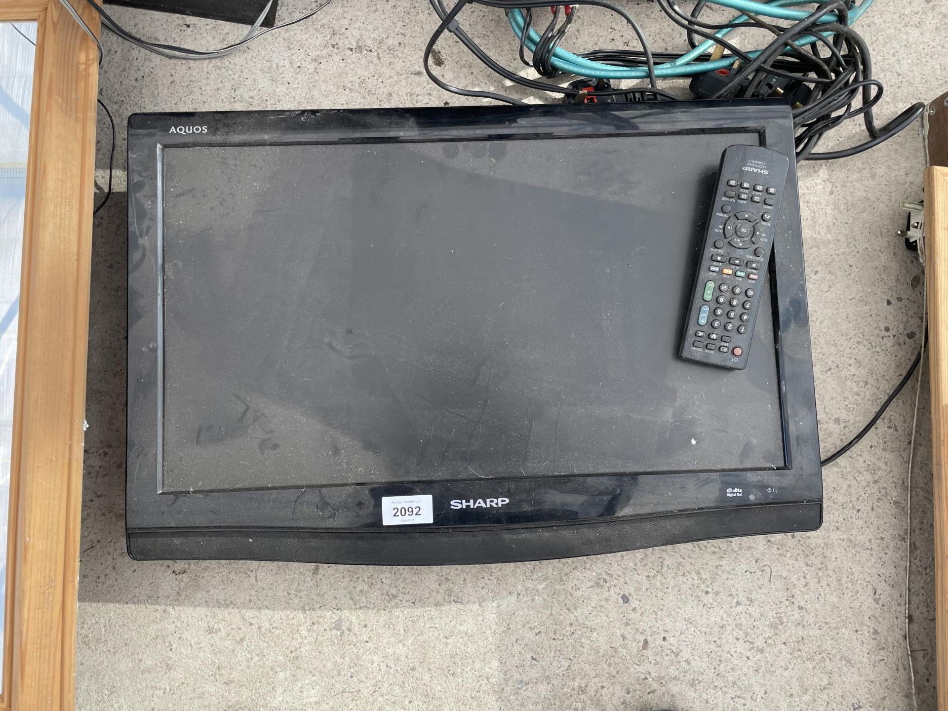 A SHARP 22" TELEVSION WITH BUILT IN DVD PLAYER AND REMOTE CONTROL