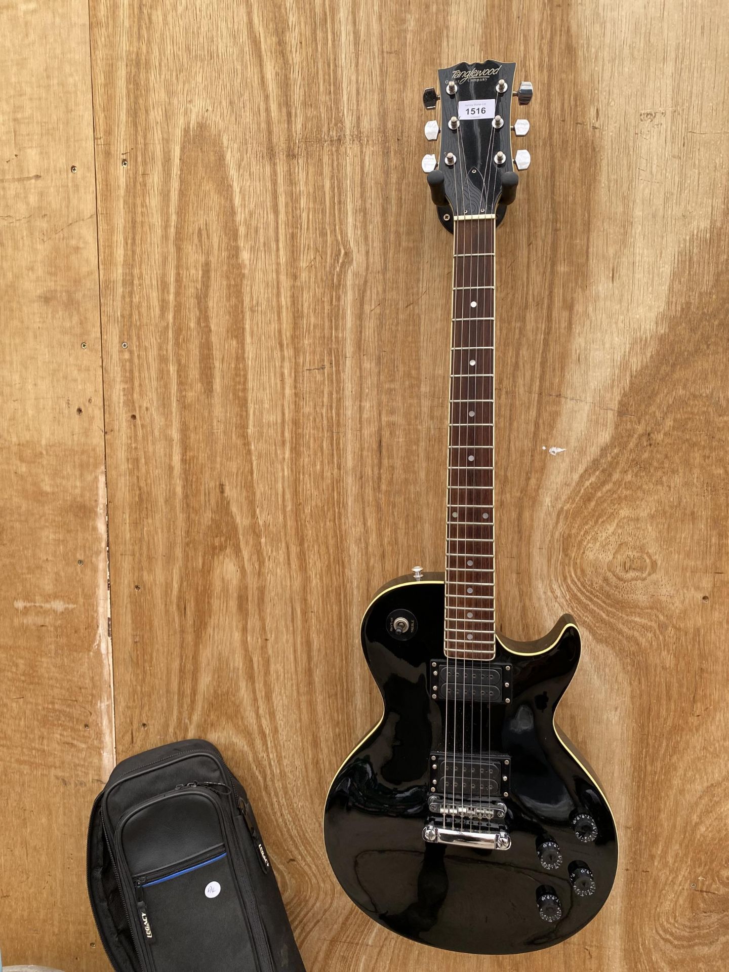 A BLACK TANGLEWOOD GUITAR COMPANY ELECTRIC GUITAR WITH A CARRY CASE, MADE IN JAPAN