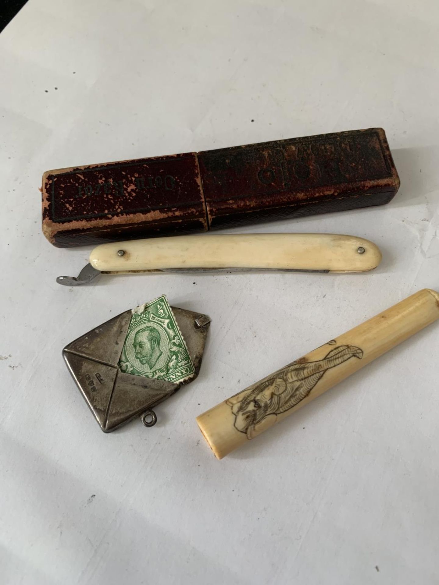 THREE VINTAGE ITEMS TO INCLUDE A BONE CHEROOT HOLDER, A HALLMARKED SILVER STAMP CASE AND A BOXED
