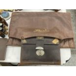 A VINTAGE LEATHER SHIRTS BAG AND A LEATHER STATIONERY WALLET