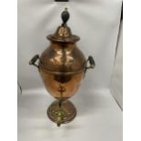 AN EARLY 20TH CENTURY TWIN HANDLED COPPER SAMOVAR URN WITH BRASS TAP