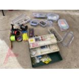 A LARGE ASSORTMENT OF SEA FISHING TACKLE TO INCLUDE REELS, LINES AND FLOATS ETC