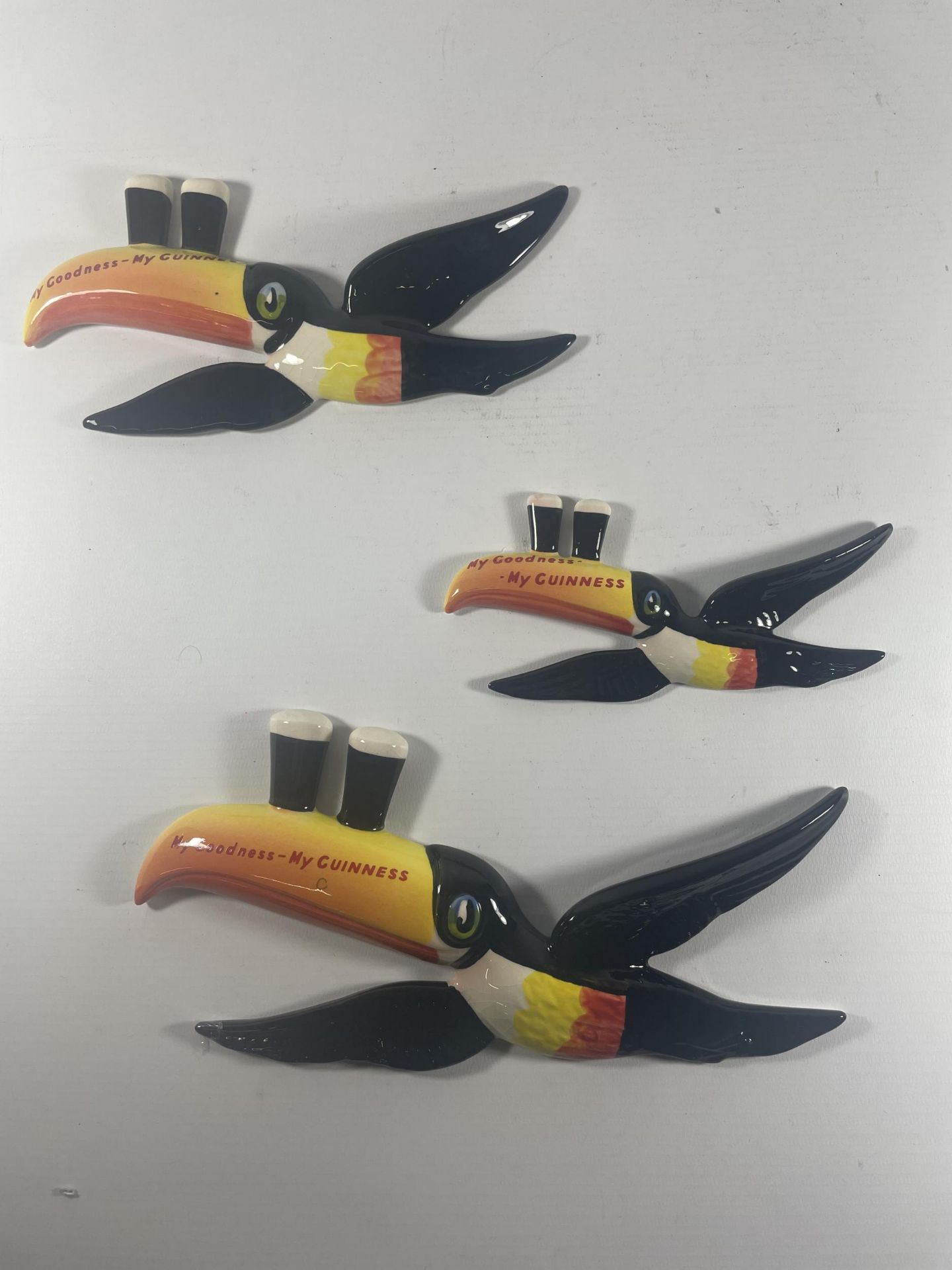 A SET OF THREE CARLTON WARE GUINESS TOUCANS