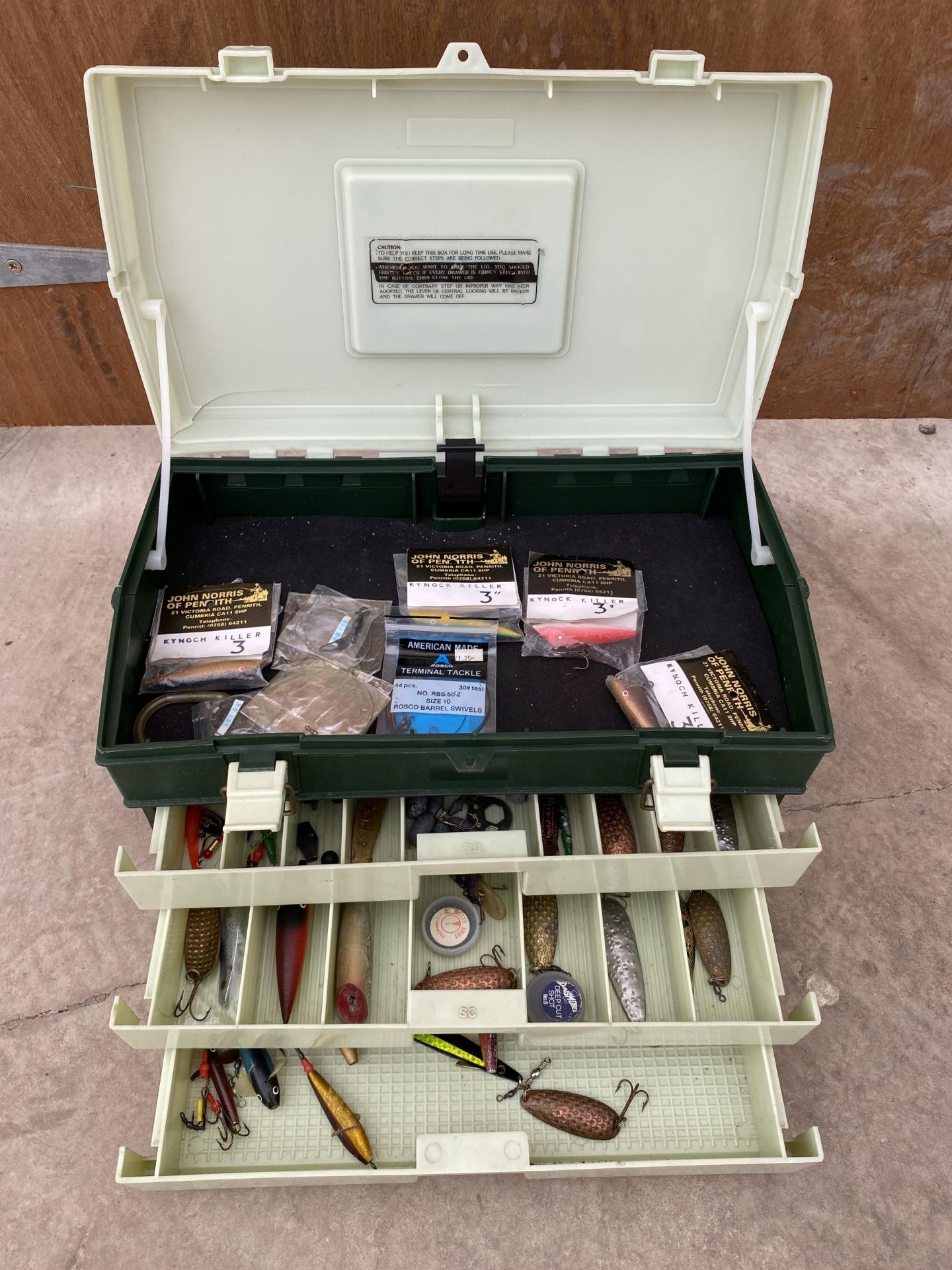 A PLANO FISHING BOX WITH A MIXTURE OF DEVON SPINNERS AND KYNOCH KILLERS ETC