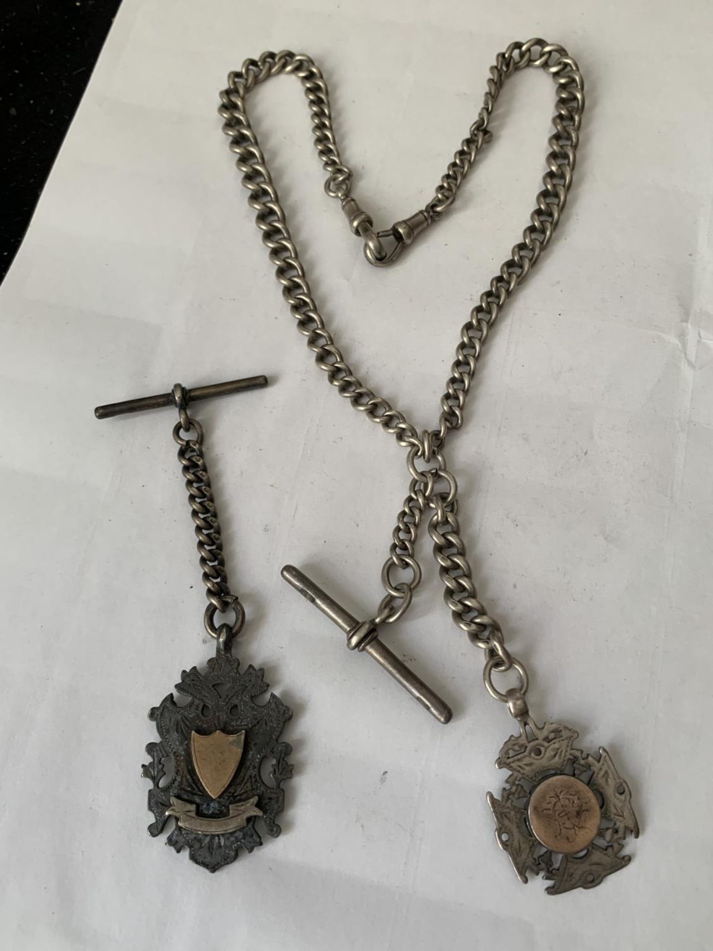 A HEAVY SILVER WATCH CHAIN WITH TWO HALLMARKED SILVER FOBS