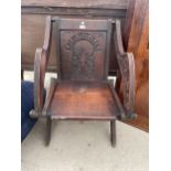AN OAK LATE 19TH CENTURY GLASTONBURY TYPE CHAIR WITH CARVED BACK PANEL
