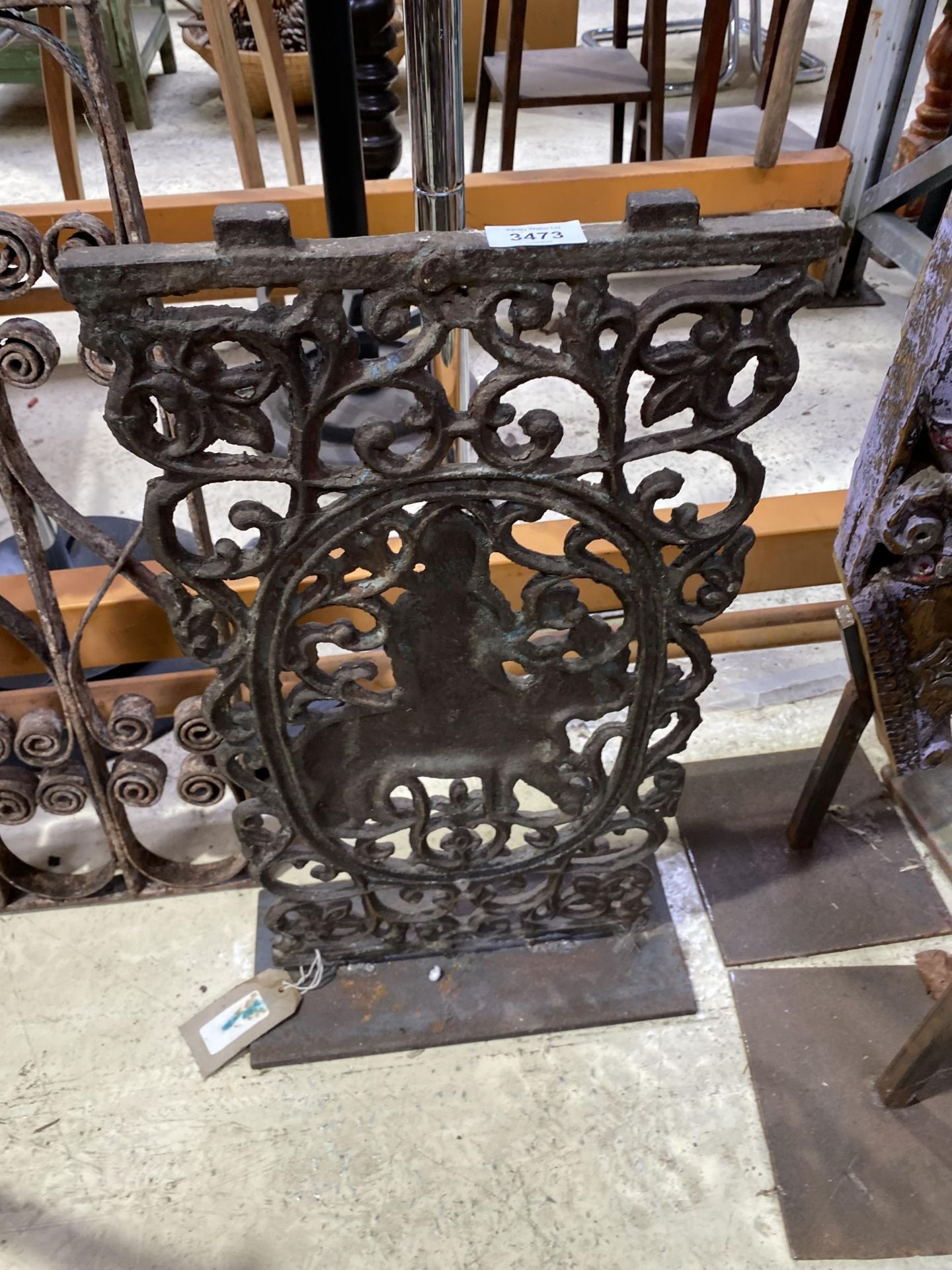 A CAST METAL ORNATE PLAQUE ON STAND, 24.5" HIGH