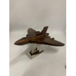 A WOODEN MODEL OF A VULCAN BOMBER ON A CHROME BASE