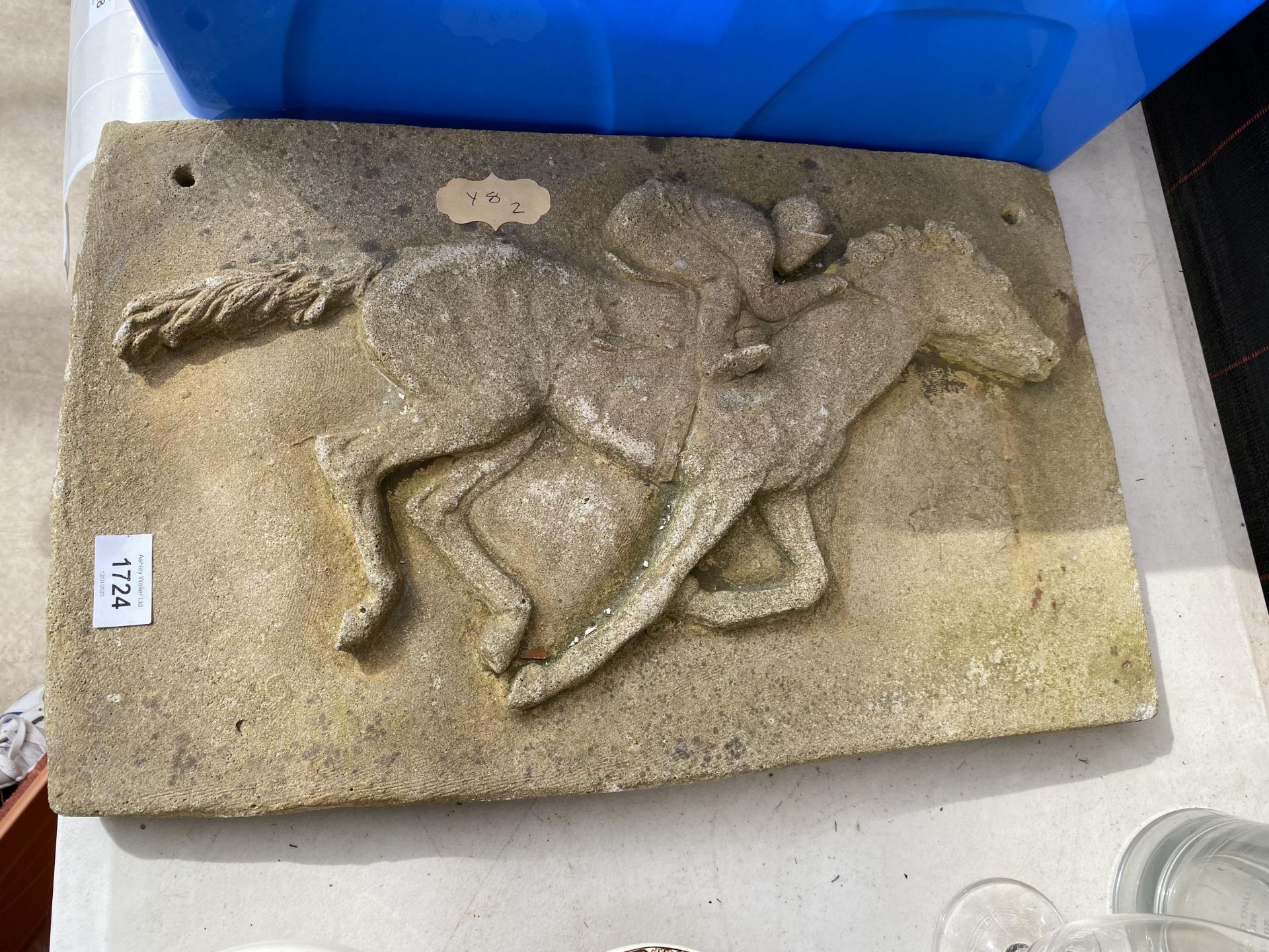 A STONE HORSE AND JOCKEY PLAQUE SIGN