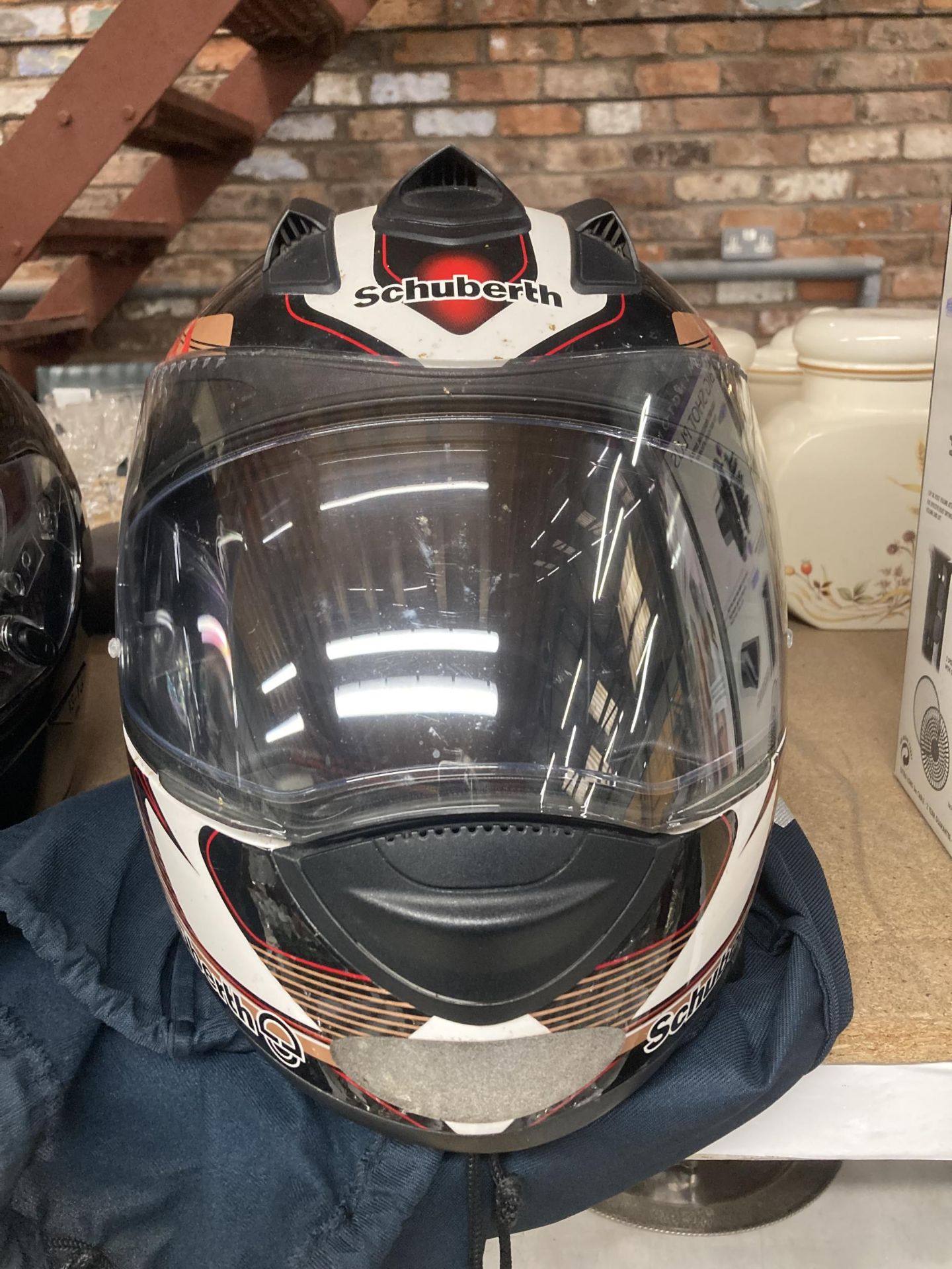 A SCHUBERTH MOTORCYCLE HELMET WITH BAG