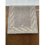 A SMALL CREAM PATTERNED RUG