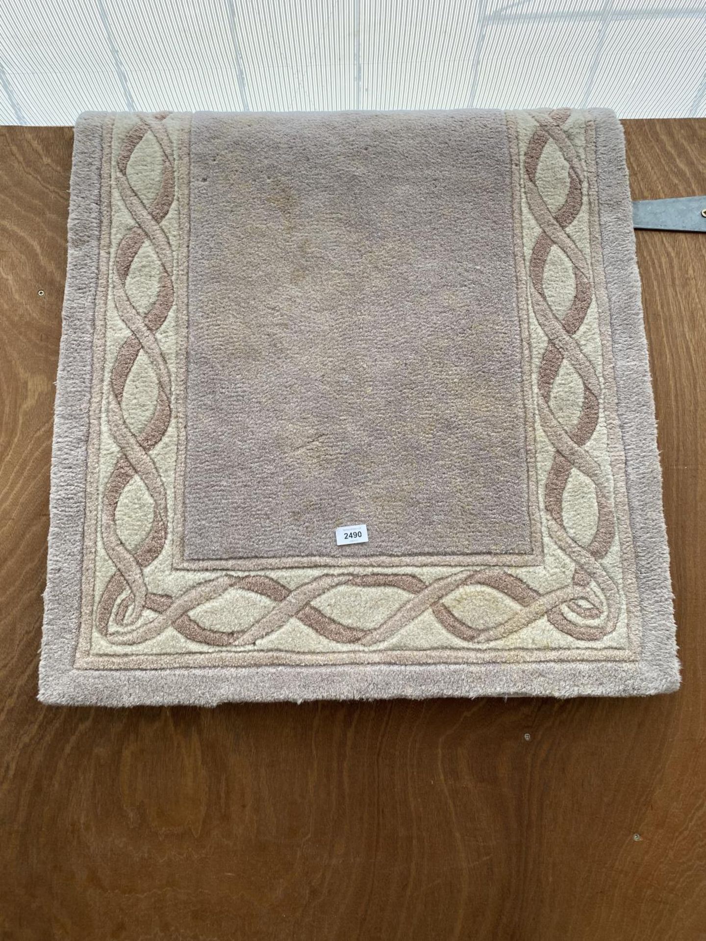 A SMALL CREAM PATTERNED RUG