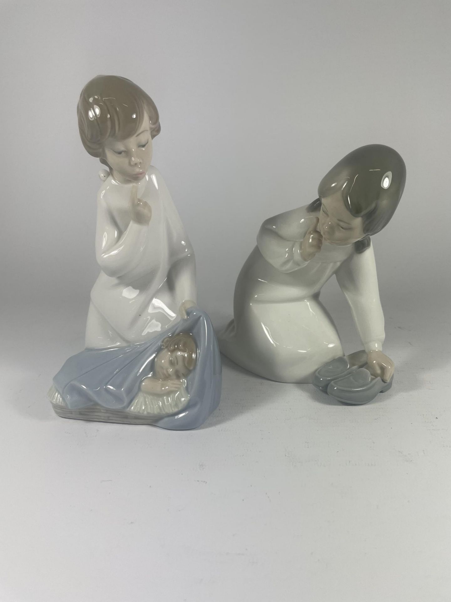 TWO LLADRO FIGURES OF A GIRL WITH SHOES & A BOY WITH CHILD