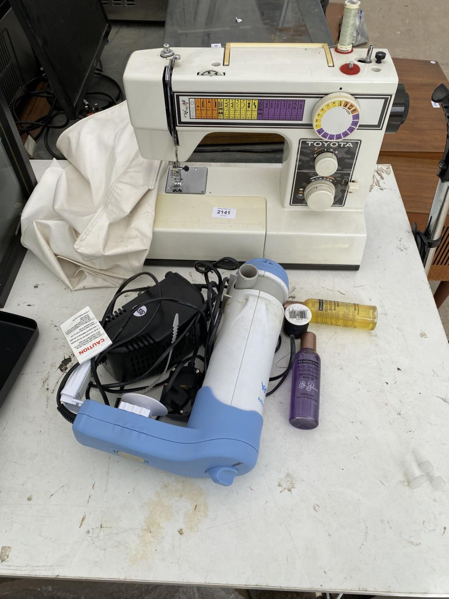 AN ELECTRIC TOYOTA SEWING MACHINE AND A REMINGTON DRYER