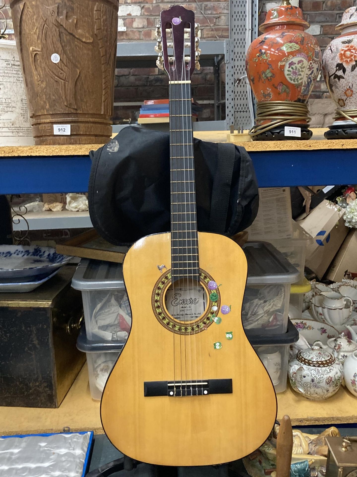 AN ENCORE CHILD'S ACOUSTIC GUITAR WITH STAND AND CASE