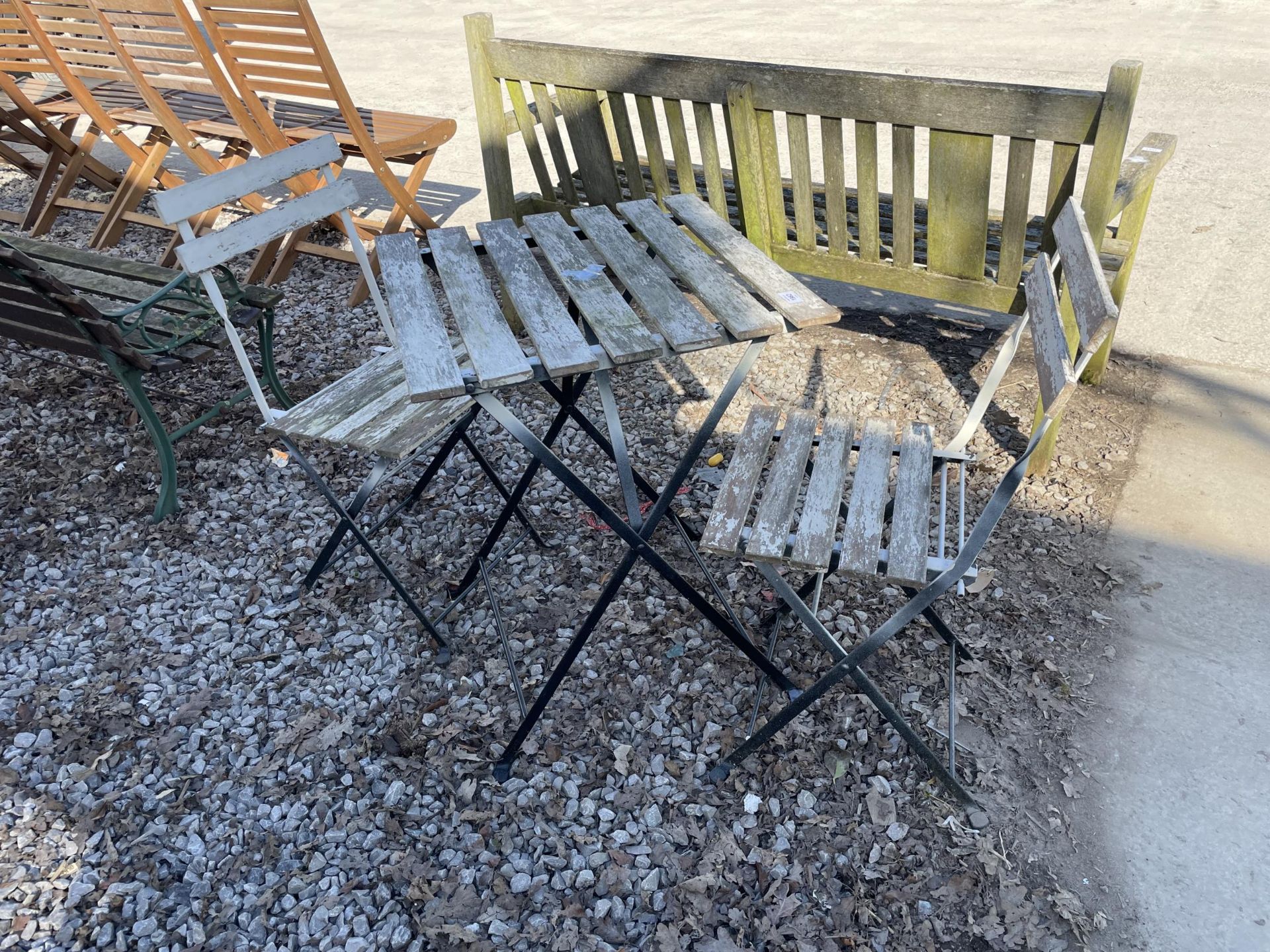 A METAL AND WOODEN SLATTED FOLDING BISTRO SET COMPRISING OF A SQUARE TABLE AND TWO CHAIRS