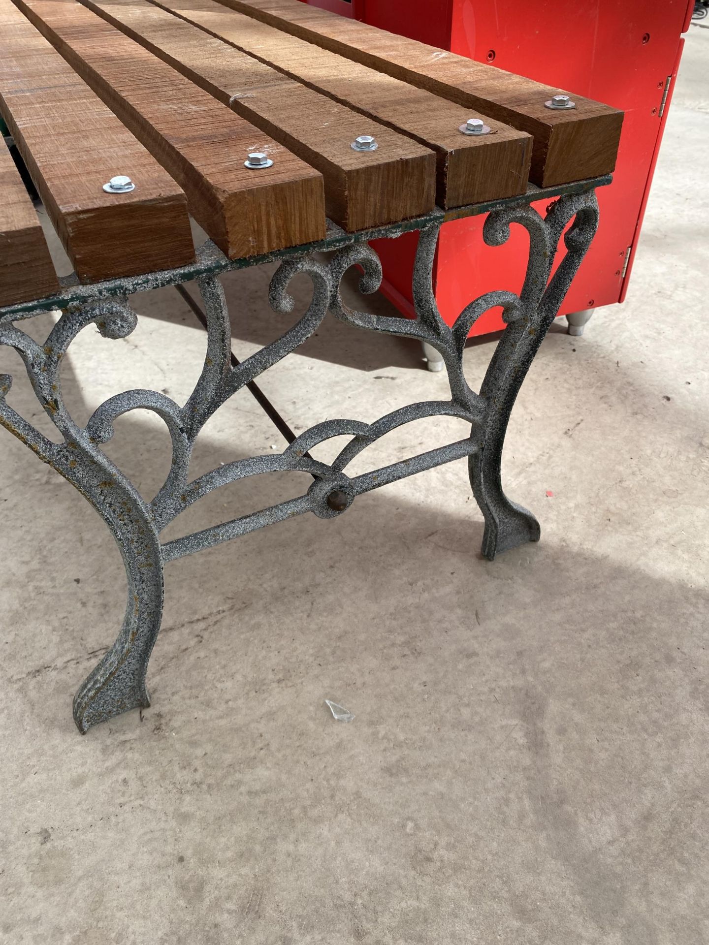 A WOODEN SLATTED BENCH WITH CAST BENCH ENDS - Image 2 of 3