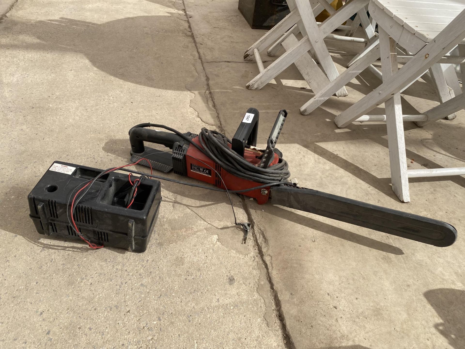 AN ELECTRIC CHAINSAW AND A BATTERY CHARGER