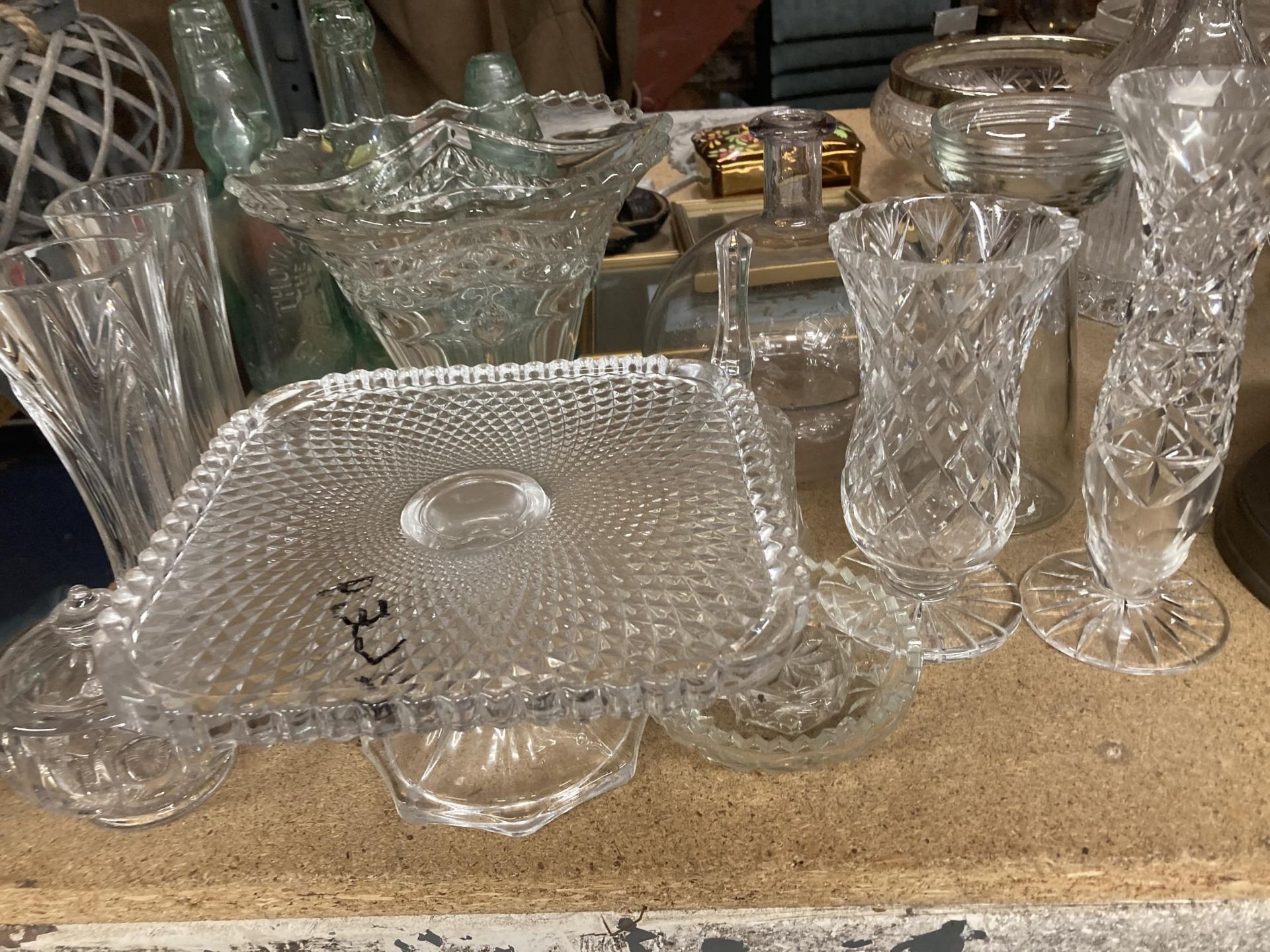 A LARGE QUANTITY OF GLASSWARE TO INCLUDE A CAKE STAND, TRINKET POT, VASES, CANDLESTICK ETC.,