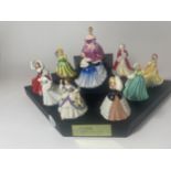 A GROUP OF TEN ROYAL DOULTON MINIATURE LADY FIGURES ON ROYAL DOULTON DISPLAY STAND