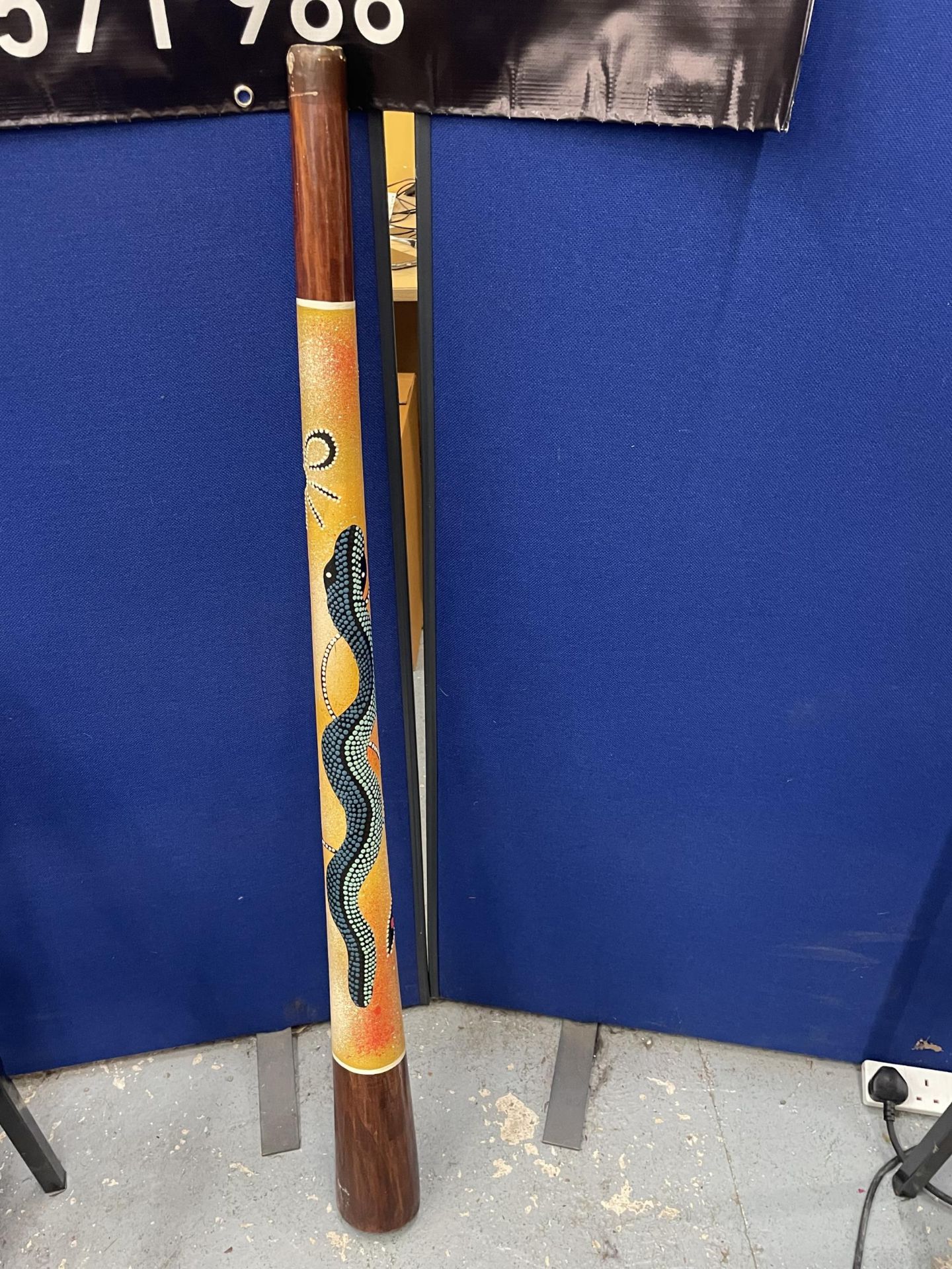 AN ABORIGINAL DIDGERIDOO WITH SNAKE DESIGN