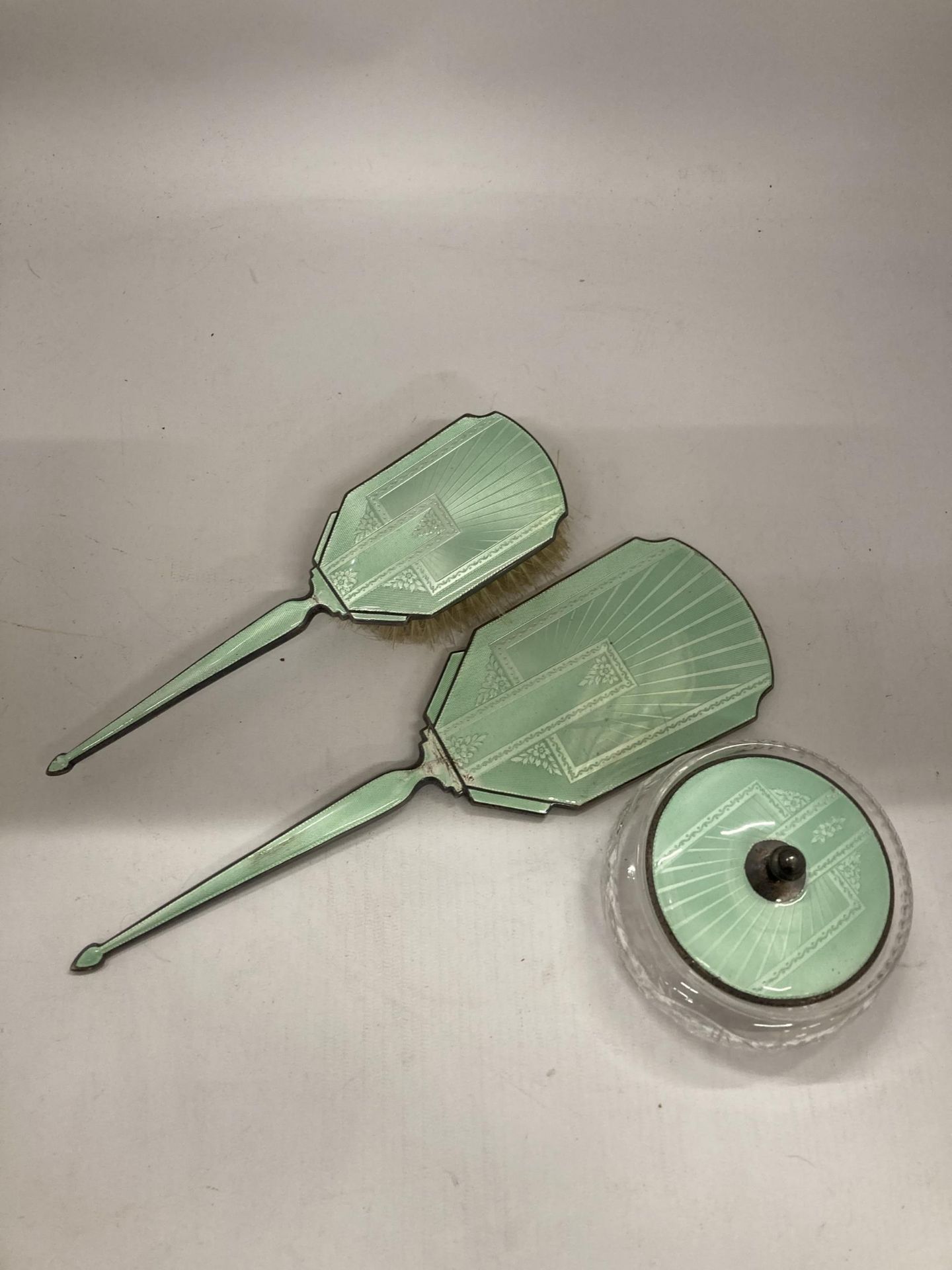 AN ART DECO HALLMARKED SILVER AND FLORAL GREEN ENAMEL THREE PIECE DRESSING SET - Image 2 of 5