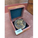 A VINTAGE BRASSS COMPASS BEARING THE STAMP' HATTON GARDEN LONDON' COMPLETE WITH WOODEN CASE