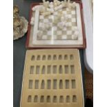 A MARBLE STYLE CHESS BOARD WITH PIECES