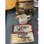 A MIXED LOT TO INCLUDE FLATWARE, A BELL'S WHISKY WATER JUG, BRASS BELL, FIGURE AND MANTLE CLOCK