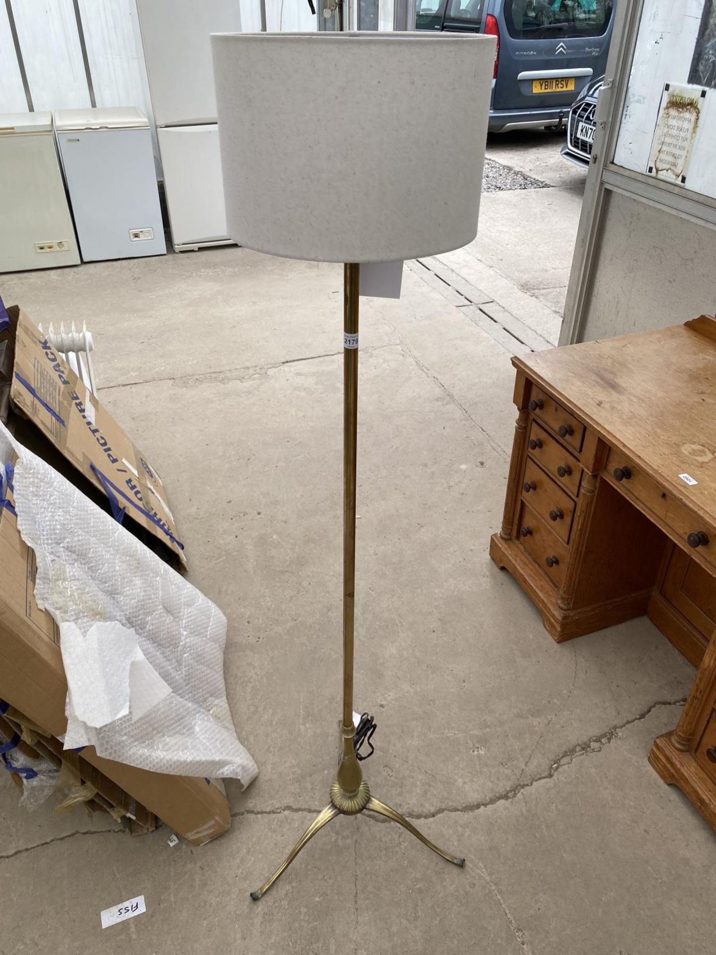 A BRASS STANDARD LAMP WITH SHADE