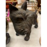 A CAST MMODEL OF A SCOTTIE DOG COCKING ITS LEG HEIGHT 17CM, LENGTH 20CM