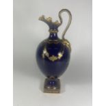 A ROYAL CROWN DERBY EWER DECORATED IN COBALT BLUE AND GILT DESIGN