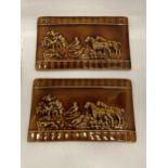 A PAIR OF LATE 19TH CENTURY TREACLE GLAZE EARTHENWARE PLAQUES WITH FOX AND HOUNDS HUNTING DESIGN, 26