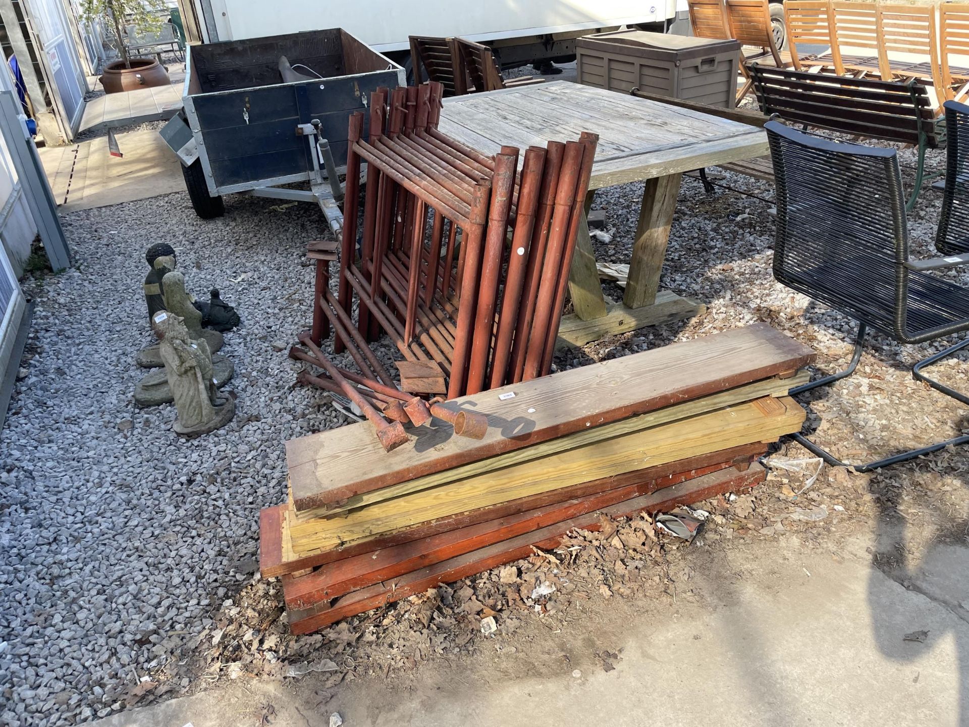 A DECORATORS SCAFFOLDING TOWER WITH WOODEN PLANKS