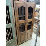 A VINTAGE INDIAN HARDWOOD OPENWORK TWO DOOR CABINET WITH BRASS HASP + IRON BAR, 35" WIDE