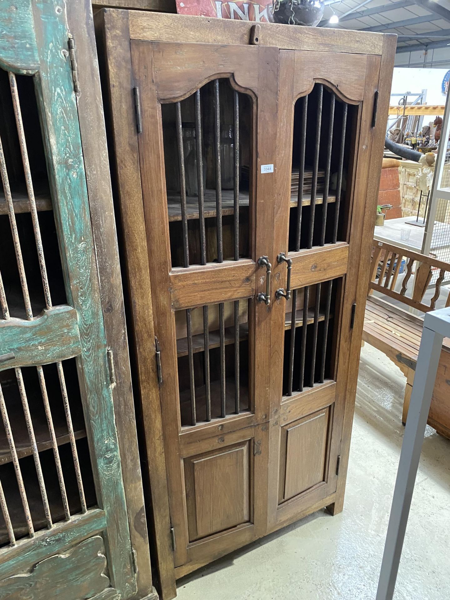 A VINTAGE INDIAN HARDWOOD OPENWORK TWO DOOR CABINET WITH BRASS HASP + IRON BAR, 35" WIDE