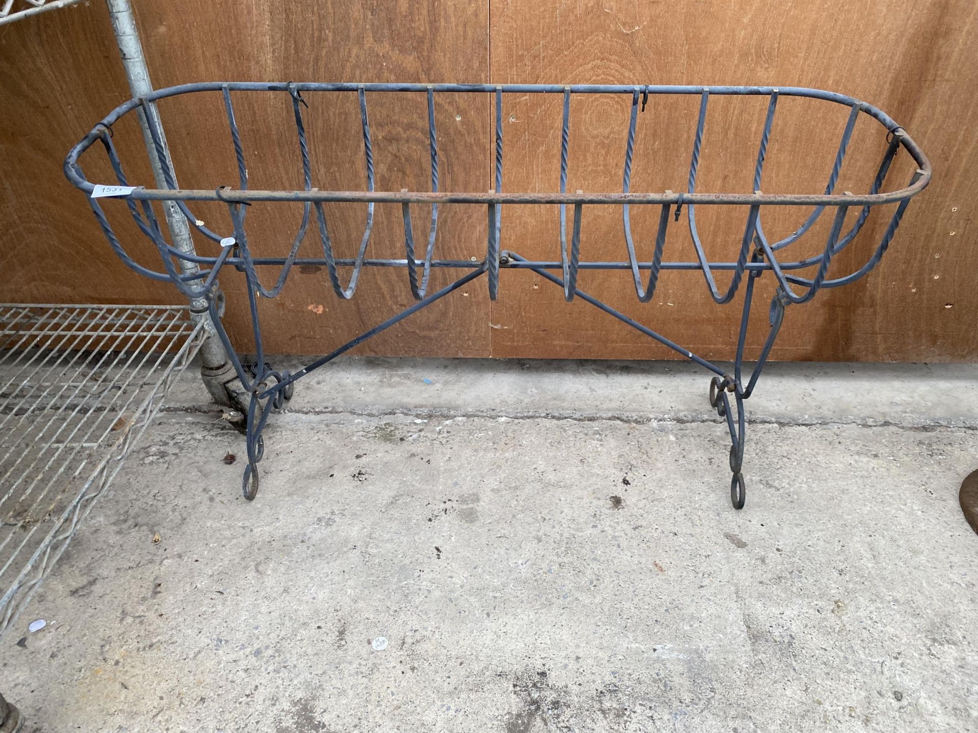 A WROUGHT IRON HAYRACK TROUGH PLANTER ON LEGS (L:91CM)