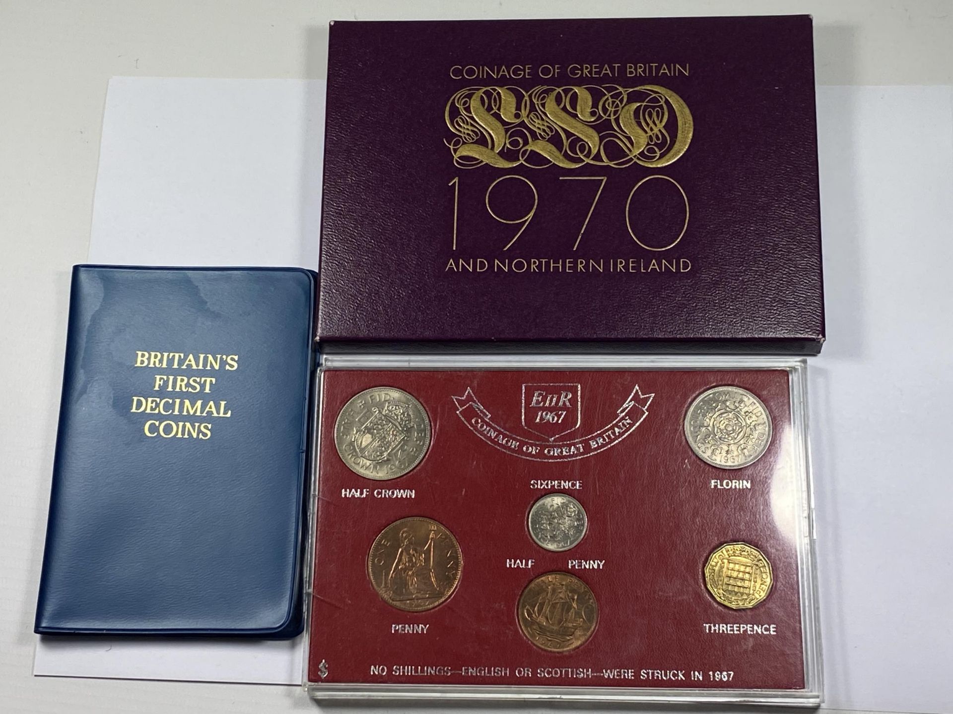 A 1970 CASED PROOF SET, 1967 SET AND A BRITAINS FIRST DECIMAL SET