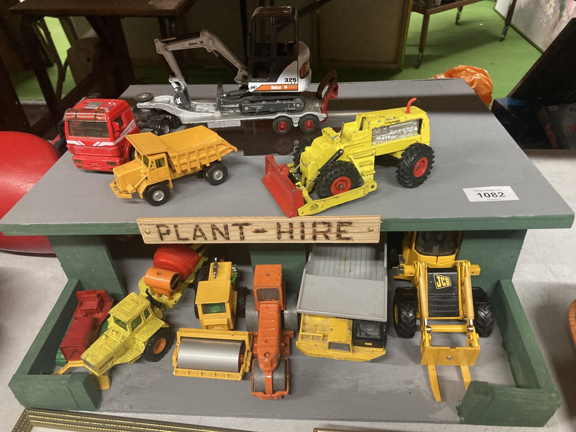 A PLANT HIRE GARAGE WITH TWELVE VARIOUS VEHICLES AND MACHINES